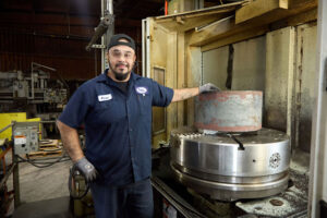man in front of large CNC machine